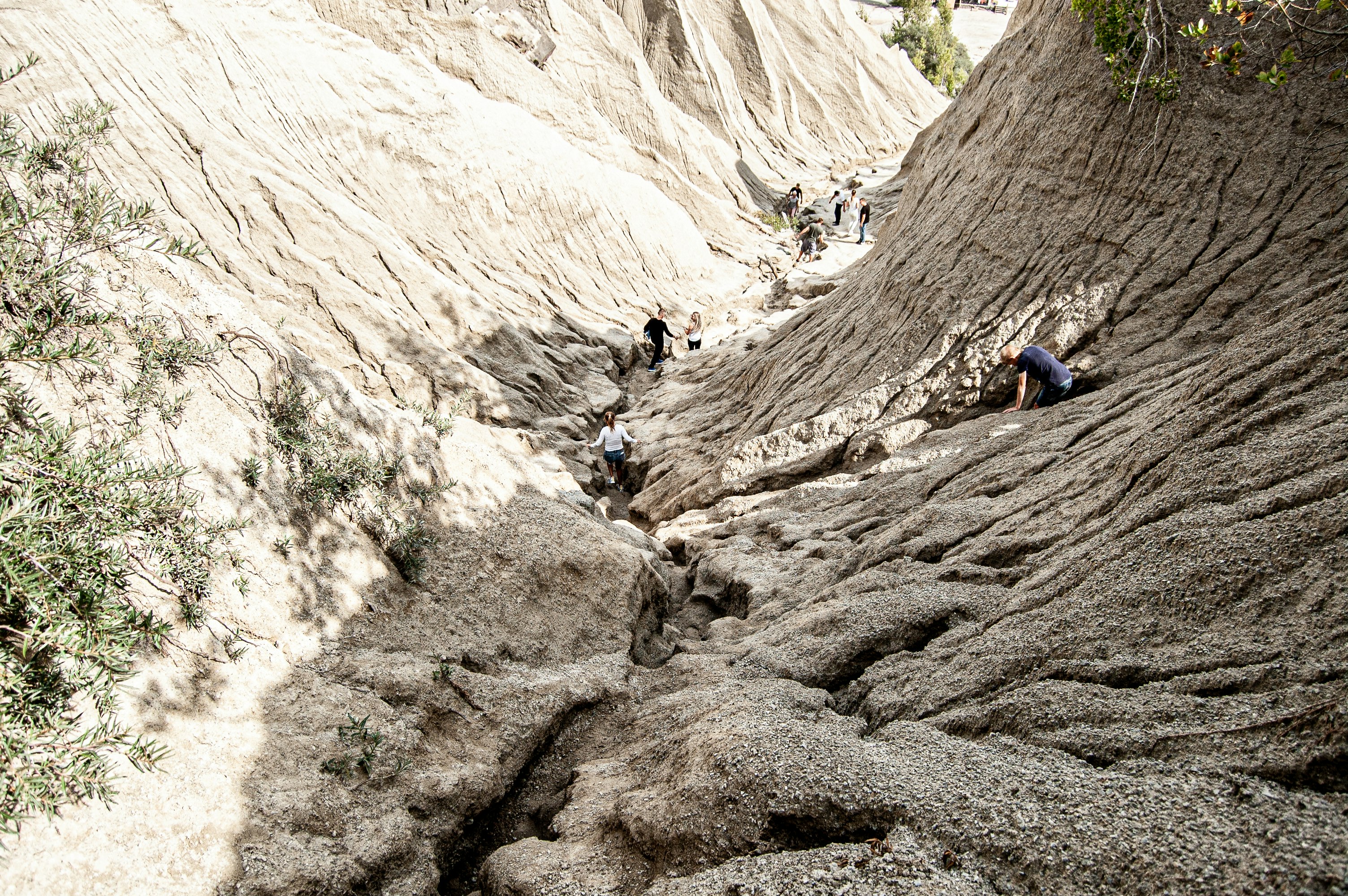 people climbing rocky mountain during daytime